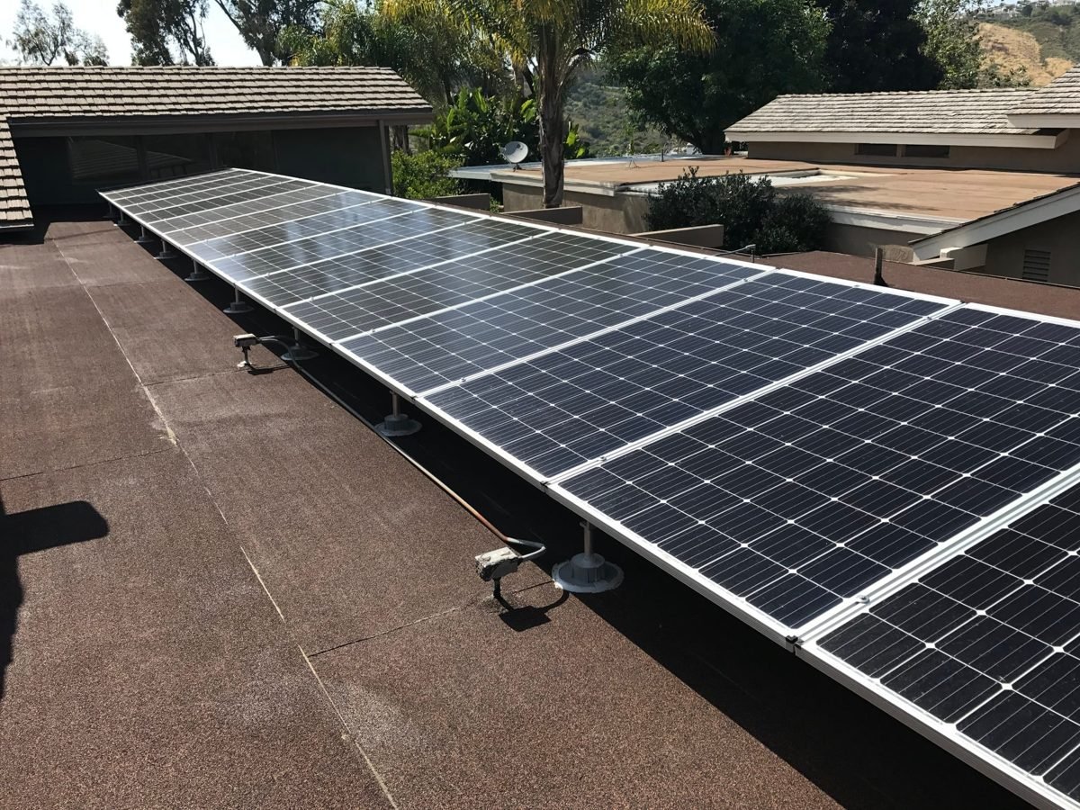 Solar array mounted on a low-slope roof after re-roofing