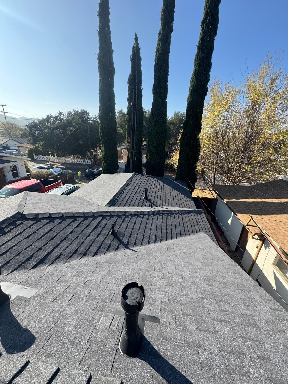 New charcoal roof surface with a replaced low-profile vent on a Valley home