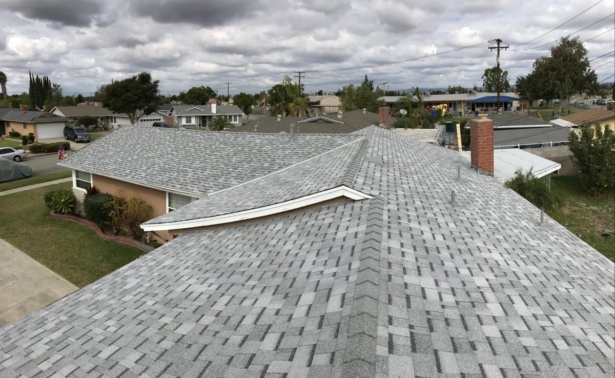 Completed grey architectural shingle re-roof on a ranch home, seen from the roof